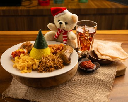Sepiring nasi kuning hangat dengan beragam lauk pauk seperti ayam goreng, telur iris, dan serundeng, siap memanjakan lidah para penikmat kuliner. Hidangan ikonik ini mencerminkan kekayaan budaya dan tradisi kuliner Indonesia yang tak lekang oleh waktu.