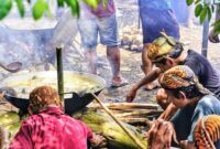 Seorang ahli pengobatan tradisional di Kutai sedang meracik bahan-bahan alami dari hutan, menunjukkan dedikasi dalam melestarikan warisan leluhur. Gambar ini menggambarkan kekayaan alam Kalimantan yang menjadi sumber utama ramuan herbal berkhasiat.