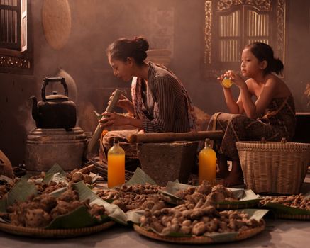 Seorang tetua adat Dayak dengan cekatan meracik ramuan herbal tradisional yang diwariskan turun-temurun, menunjukkan keahlian dan kearifan dalam memanfaatkan kekayaan alam Kalimantan.
